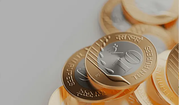 Close-up of stacked Indian rupee coins.